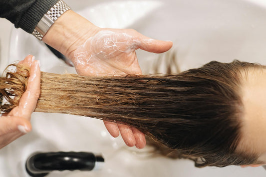 peluquera añadiendo acondicionador de pelo