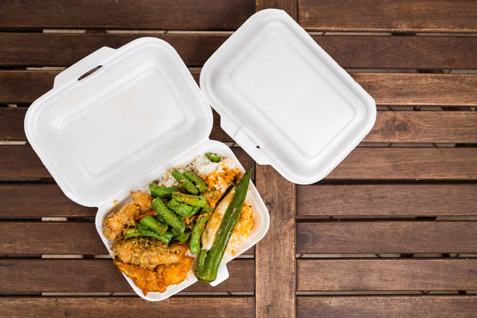 Envase blanco de plástico de comida rápida en un fondo de madera